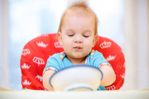 istock One year old child plays in the kitchen with dishes 939250930