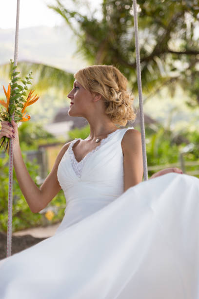 istock Close-up portrait of a beautiful bride on a tree swing 939252466