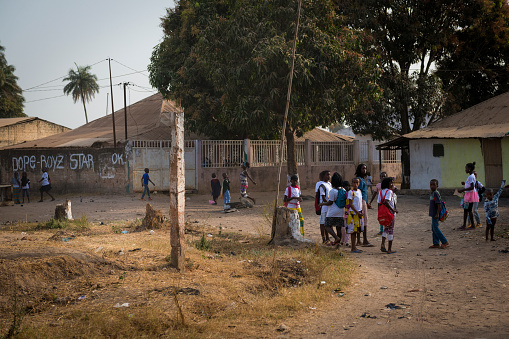 Bissau, Republic of Guinea-Bissau - January 29, 2018: Group of children playing outside their school after the classes, at the Bissaque neighborhood in the city of Bissau, Guinea Bissau.