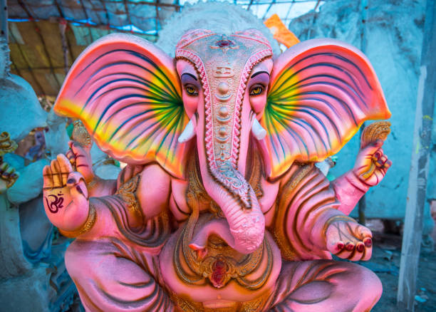 Large pink Ganesha statue- brightly colored Hindu and Buddhist deity god Ganesha is the remover of obstacles. Ganesha often appears as a seated elephant with multiple hands and a broken tusk. These statues are concrete sculptures, standing 4-6 feet high. View my portfolio for similar shots of this and others. religious symbol photos stock pictures, royalty-free photos & images