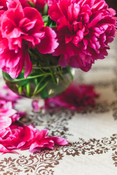 istock red peonies in glass vase stand on table 939261622