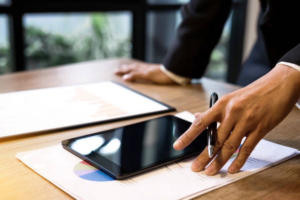 istock Professional business woman working, Doing finance on digital tablet, document graph and analysis business strategy to development profit 939261952