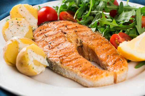 istock Grilled salmon with arugula salad and potatoes 939266176