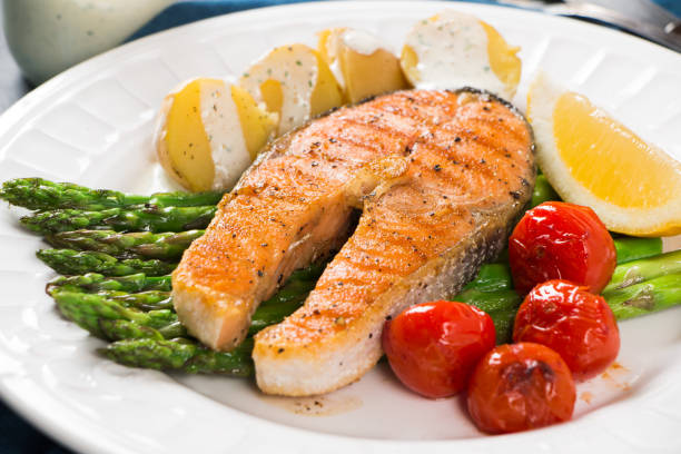 istock Grilled salmon with green asparagus, cherry tomato and potatoes 939268302