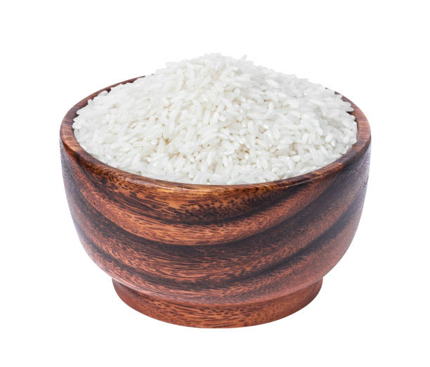 istock Basmati rice groats in wooden bowl isolated on white background 939269122