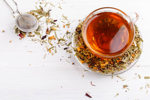 istock Herbal tea in glass cup on white table. 939270074