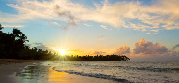istock Caribbean sunset on tropical beach 939276288