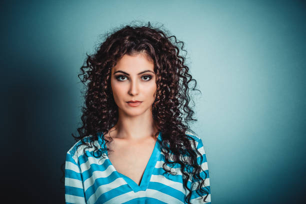 Hair concept and beauty concept of a mixed race woman with green eyes and an updo in her hair. The beautiful woman is of african american and middle eastern descent.