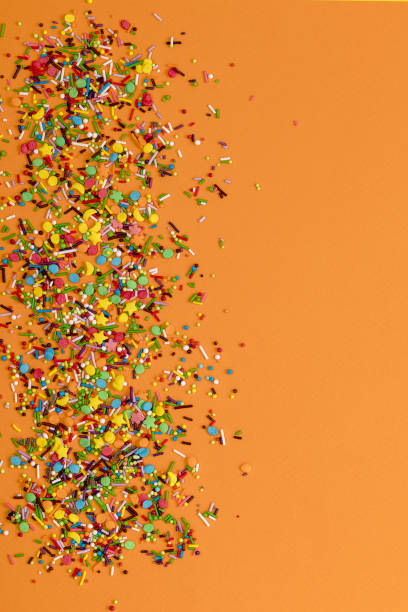 istock Easter decoration with candy powder colorful on orange background. 939281364