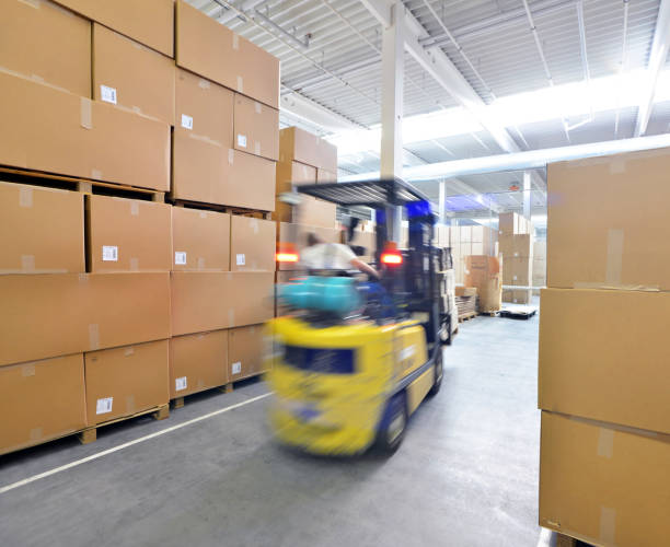 istock forklift driver in a warehouse for industrial goods 939283774
