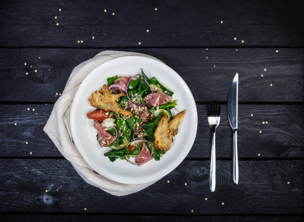 istock Spinach salad with roast beef and mushrooms in breadcrumbs. 939283834
