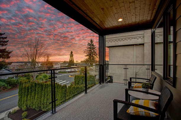Modern house exterior with a deck at sunset.