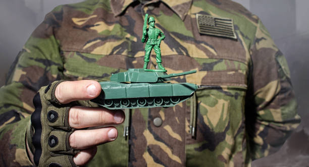istock Soldier toy standing on tank. 939284372