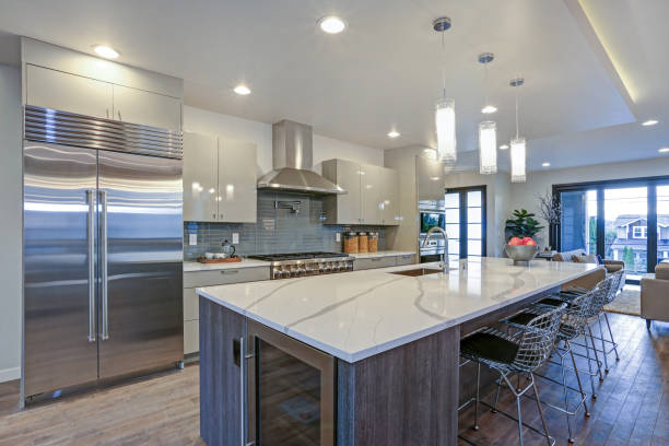 Sleek modern kitchen design with a gray center island stock photo