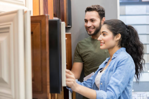 istock Couple browse cabinetry display in hardware store 939287304