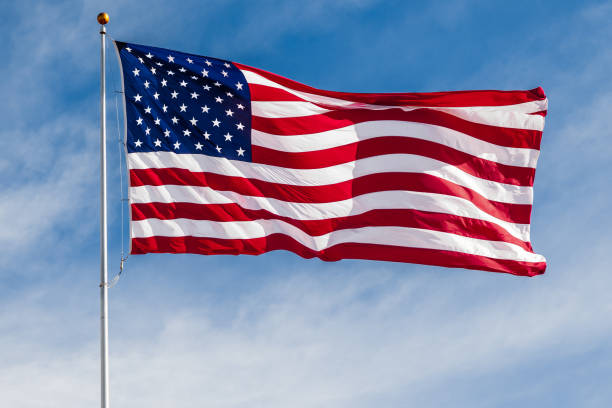 American flag waving against blue sky