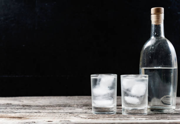 vodka froid en verres sur un fond noir - shot glass glass black empty photos et images de collection