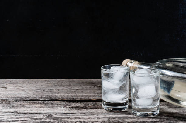 istock Cold vodka in shot glasses on a black background 939287768