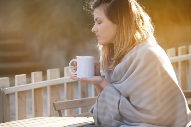 istock Dreamy girl drinking coffee in chilly morning, backlight 939288170