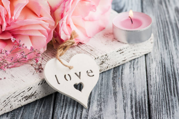 istock Pink roses, lit candle, heart 939288218