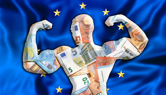 Abstract business background. Concept of powerful European EURO. Flag of Europe and bodybuilder shaped EUR currency. Financial concept about exchange rate of European Euro currency.