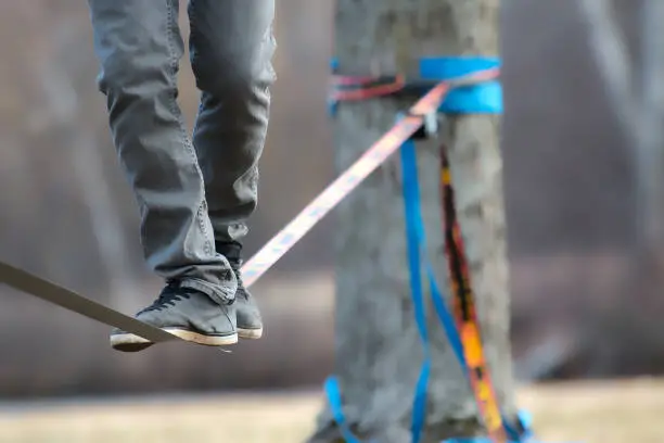 teen practicing his slackline skills