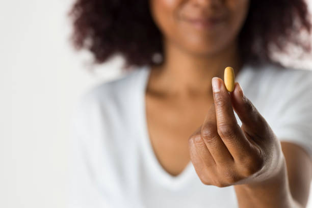 istock Woman Showing Pill 939291174