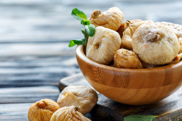 istock Wooden bowl with dried figs. 939303328
