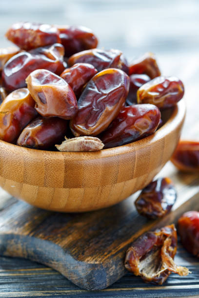 istock Dried date fruit in a wooden bowl. 939303910