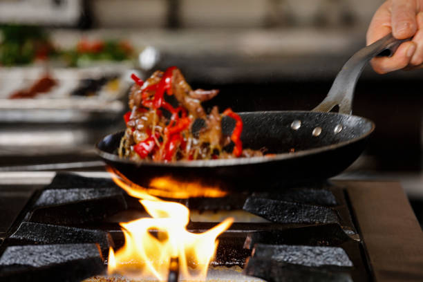 istock Professional Chef Cooks Flambe Style. 939310622