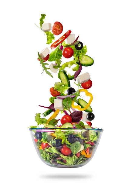 Flying vegetable greek salad isolated on white background Flying vegetable greek salad isolated on white background. Healthy eating and lifestyle. Very high resolution image spring mix lettuce leaves stock pictures, royalty-free photos & images