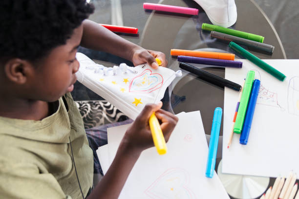 istock African-american preteen kid doing a craft project. 939310792
