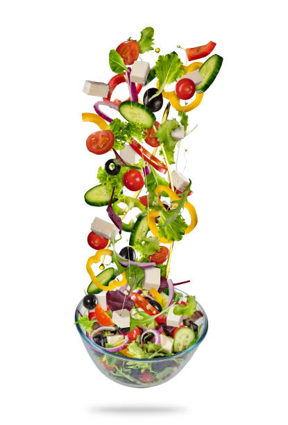 istock Flying vegetable greek salad isolated on white background 939310830