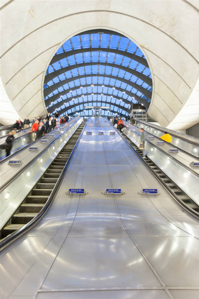 istock Commuters on Escalators Descending into Subway Station in Canary Wharf, London 939310862