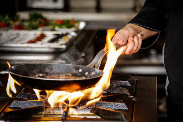 istock Professional Chef Cooks Flambe Style. 939311006