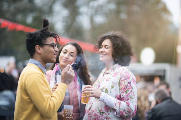 Festival : friends having a drink together and smoking a cigaret