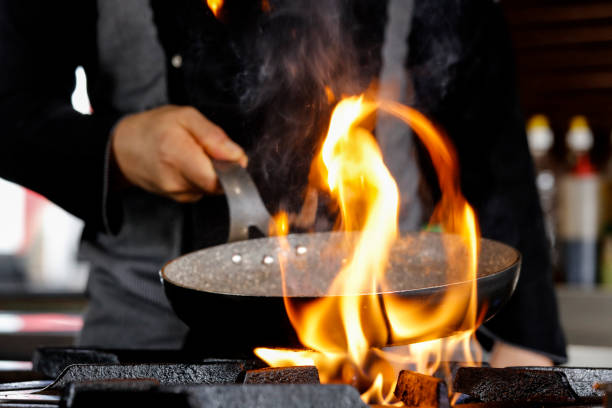 istock Professional Chef Cooks Flambe Style. 939313612