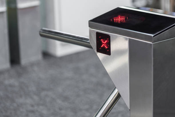 Closed entrance turnstile with access denied red sign. Security barrier