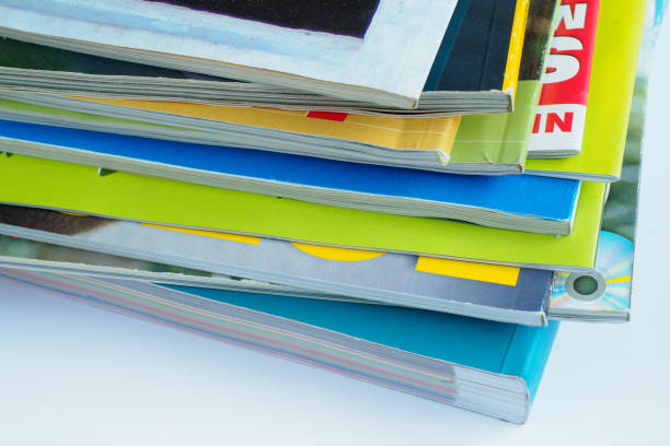 istock Magazines with selective focus on foreground edge. Edge stack of the colorful magazines 939317436
