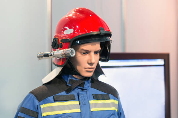 istock Exhibition firefighter dummy in fire fighter helmet and uniform. Protective rescue wear. Head light torch 939320880