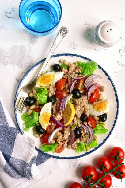 istock Tuna salad with white beans, tomatoes, boiled eggs and black olives 939322312