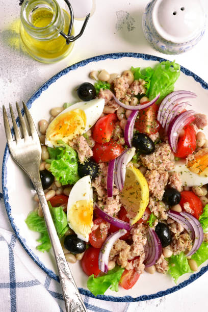 istock Tuna salad with white beans, tomatoes, boiled eggs and black olives 939322434