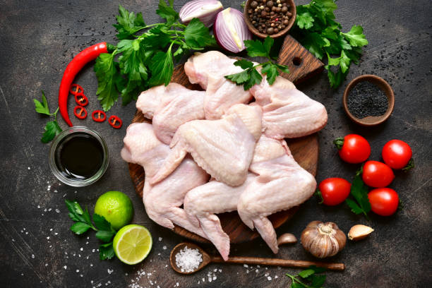 istock Raw chicken wings with ingredients for cooking 939322756