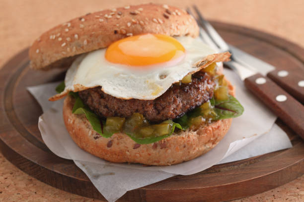 istock Hamburger with fried egg and gherkin salad 939325170