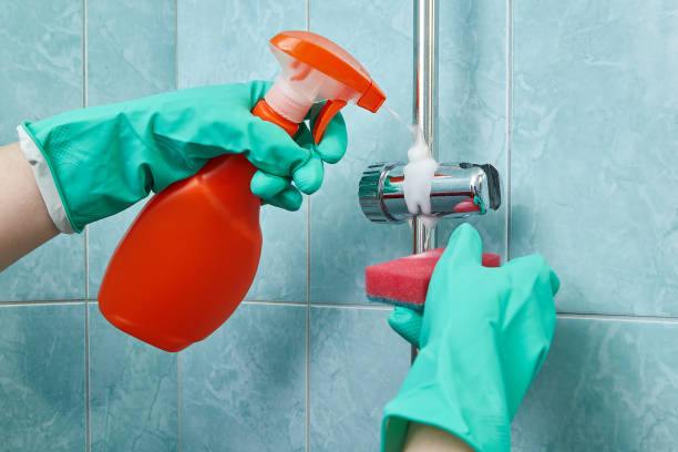 istock Woman - cleaner uses protective gloves while cleaning in bathroom. 939328558