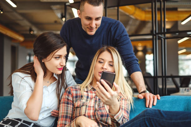 istock Friends looking at mobile phone and having fun 939332662