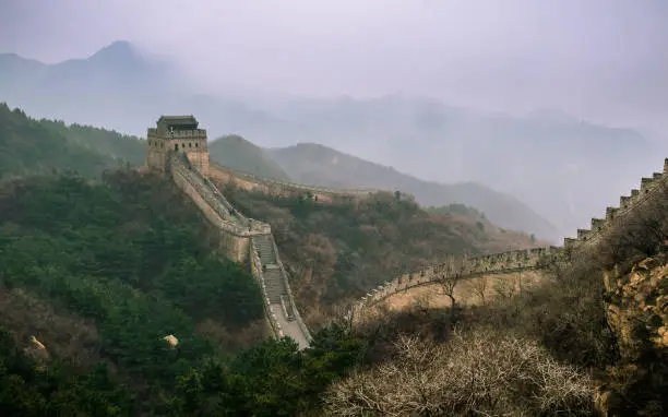A very cold early morning view of the Great Wall of China where the mist of the night still lingers.