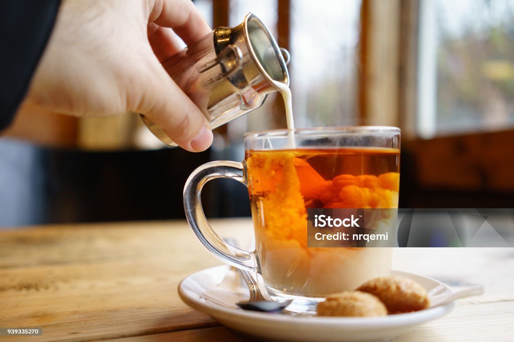 Adding milk top on English Tea English Tea with Milk on wooden table Tea - Hot Drink Stock Photo