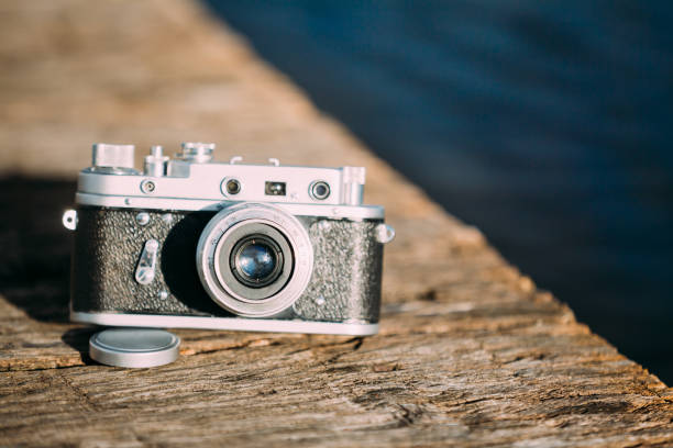 istock 35mm Vintage Old Retro Small-Format Rangefinder Camera On Old Wooden Board Desk 939338440