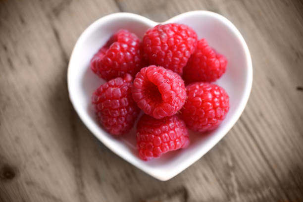 istock Berries: rasberries on a wood background 939338520